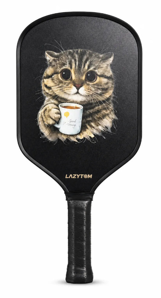 A black pickleball paddle featuring a printed illustration of a tabby cat holding a white mug, with the LAZYTOON brand name printed in gold near the base of the handle.